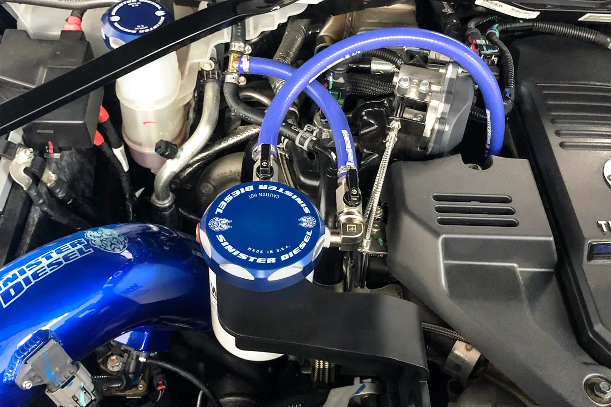 Sinister Diesel blue coolant filtration system installed in a Ram Cummins engine compartment
